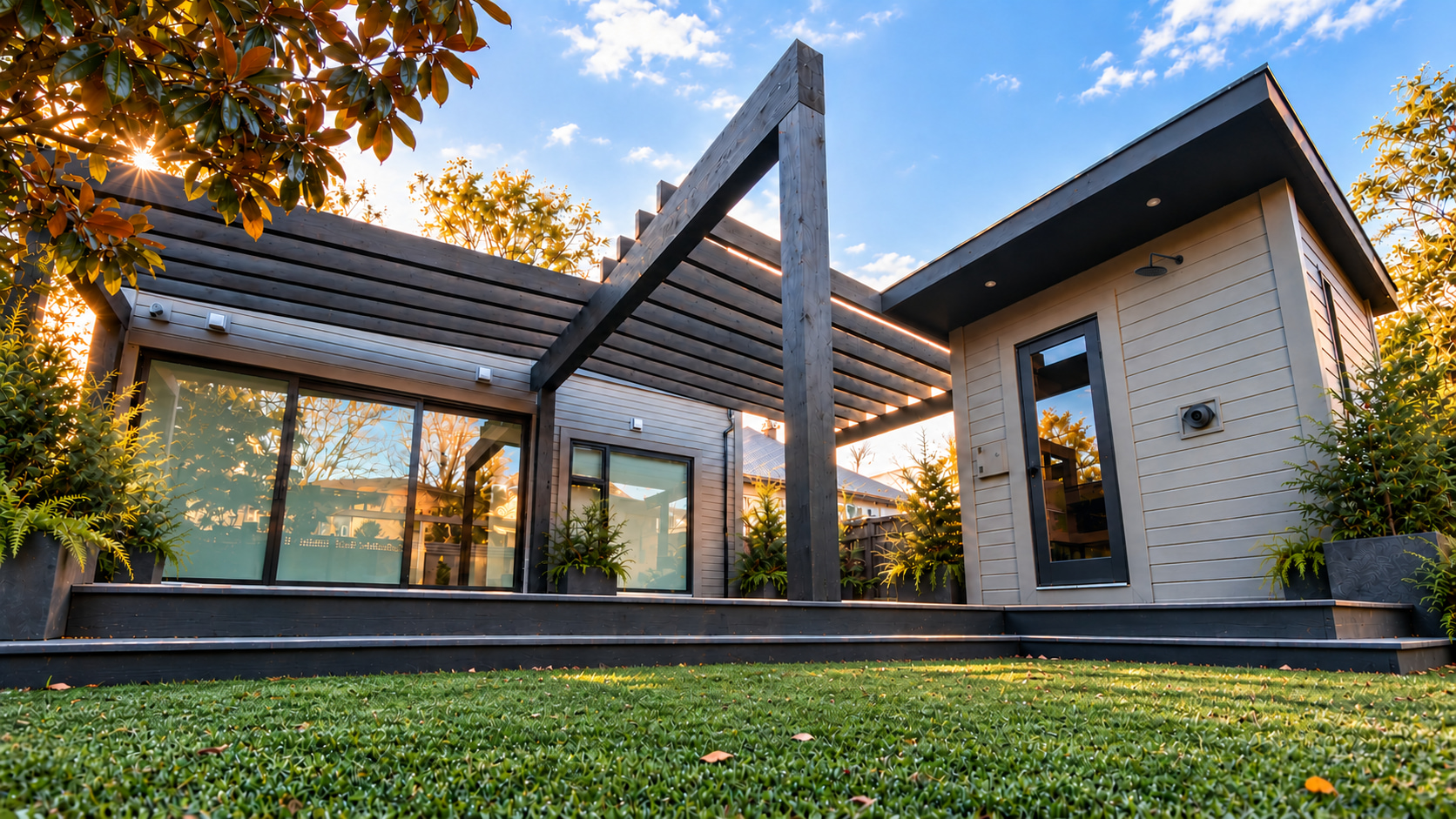 Grant Street timber pergola, deck and outdoor sauna with a black rain shower, with warm sunlight through magnolia leaves and cedar planting